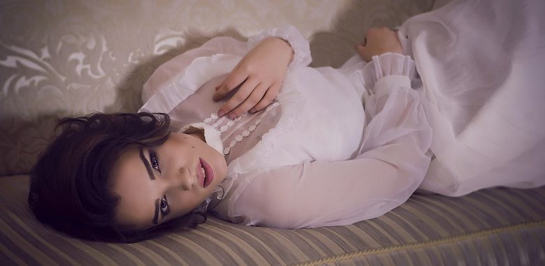Disabled model Alexandra Kutas lying on sofa
