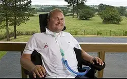 Matt pictured in a power chair at the Get Busy Living Centre