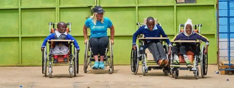 Arielle Rausin racing disabled children in wheelchairs