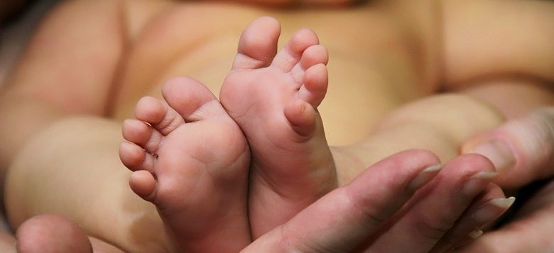 Baby being held by parent