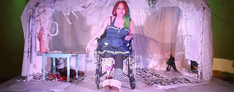 Amputee Jackie Hagan on stage in wheelchair