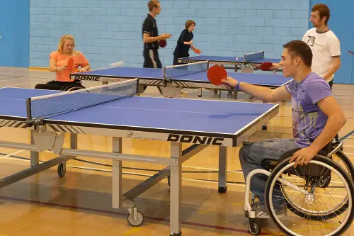 Man in wheelchair playing table tennis