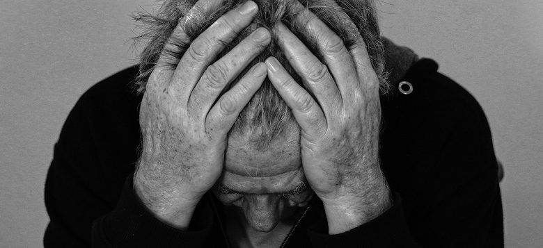 Man with learning disabilities with head in hands