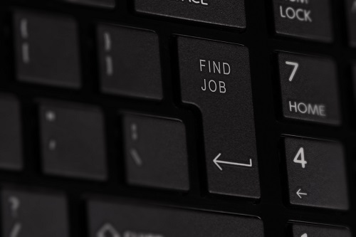 Computer keyboard with words 'find job' on the enter key