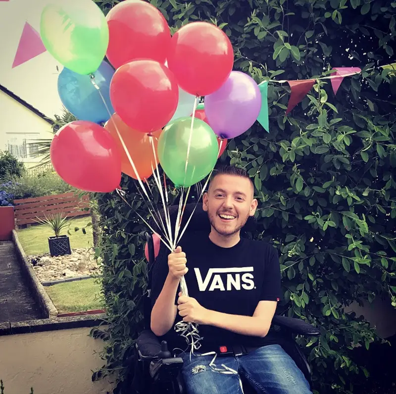 Ross Lannon holding baloons