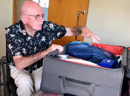 Disabled traveller Wolf packing his suitcase for holiday
