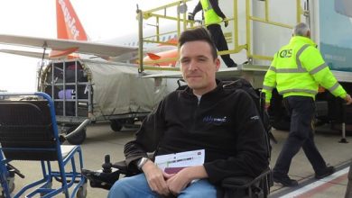 Josh in his wheelchair outside an aircraft