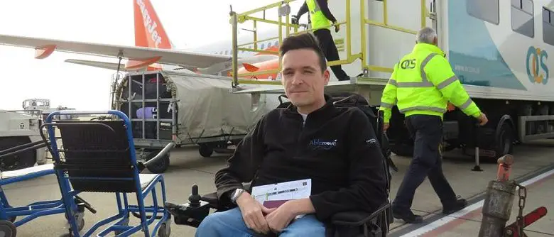 Josh in his wheelchair outside an aircraft