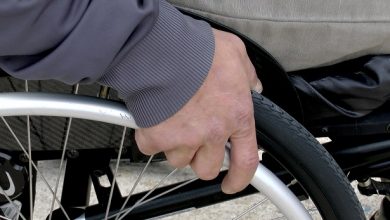 Disabled man's hand on his wheelchair wheel
