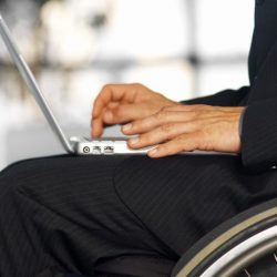 Wheelchair user working at a desk