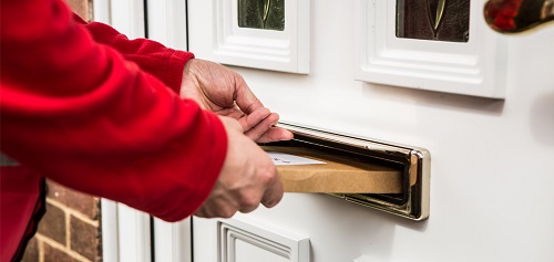 A prescription being posted through a letter box