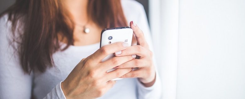 Woman using a disabled dating app on a mobile phone