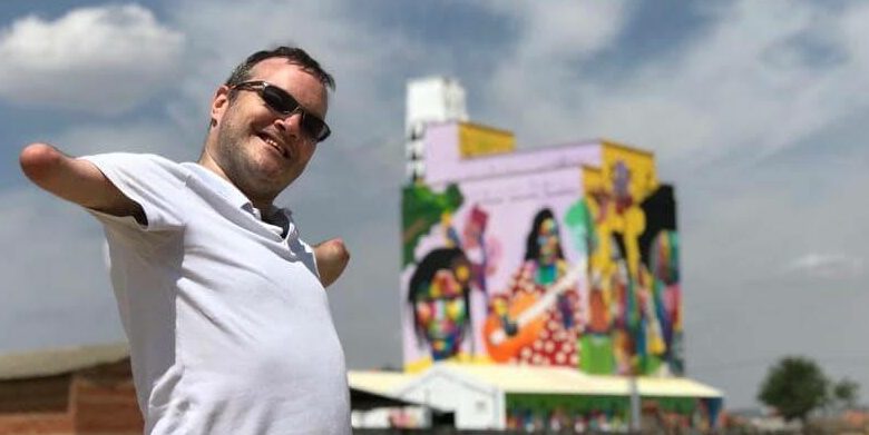 Paul Carter posing by a billboard