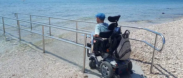 Wheelchair user Martyn Sibley at beach in Croatia on a ramp