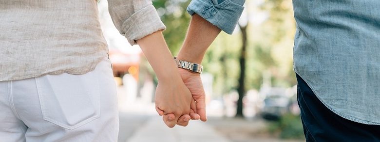 Couple holding hands outside