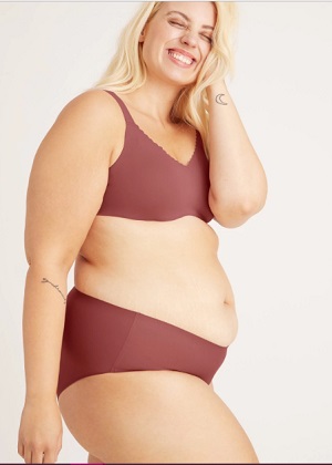 Woman in underwear showing rounded stomach and curves