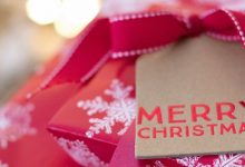 Christmas presents in red wrapping paper with snowflakes and a tag saying Merry Christmas