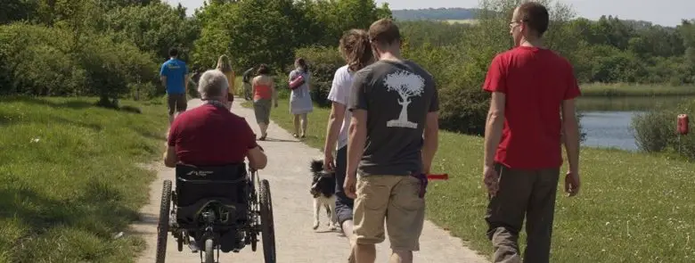 Richard Brooks on his Mountain Trike all-terrain wheelchair taking a walk with friends