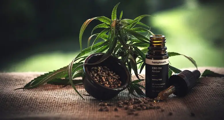 Cannabis leaves on hessian bag with cbd oil