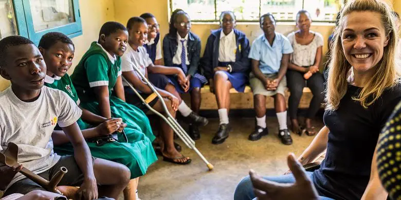 Sophie Morgan with a group of young disabled children in a classroom in Africa