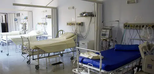 Four hospital beds in a hospital ward