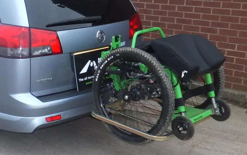 Mountain Trike all-terrain wheelchair on a Bak-Rak attached to the back of a car