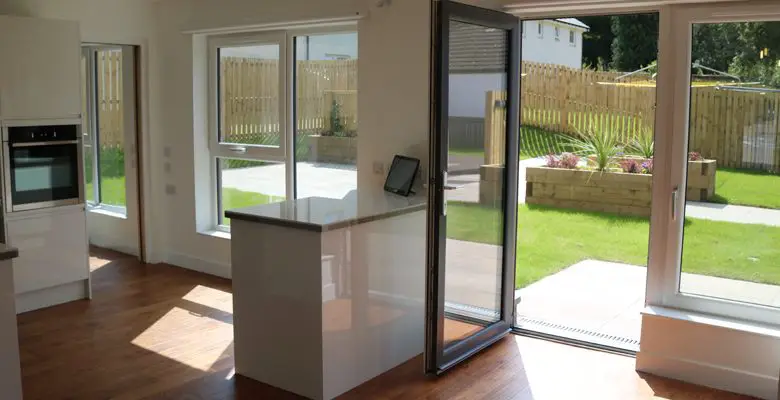 Open-plan kitchen and living area in accessible home by Blackwood