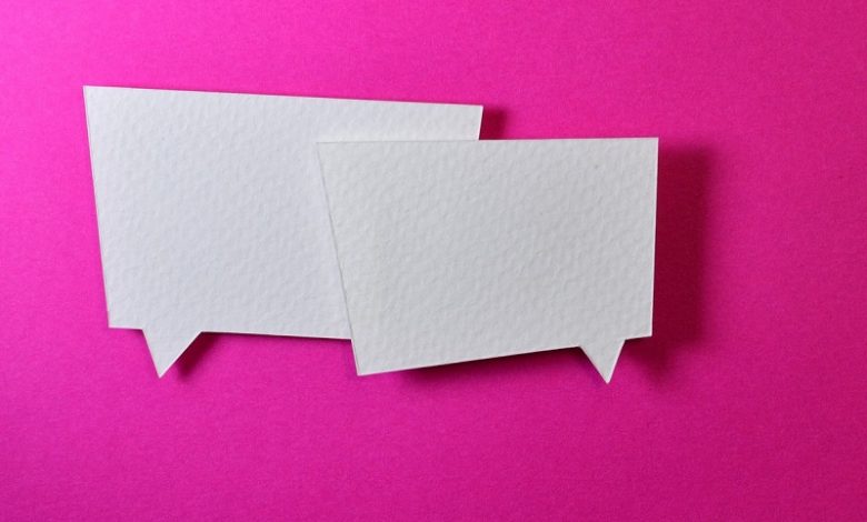 Two white speech bubbles on bright pink background