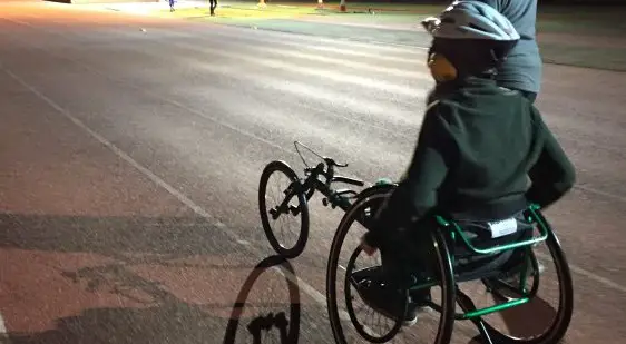 Disabled boy in wheelchair on race track