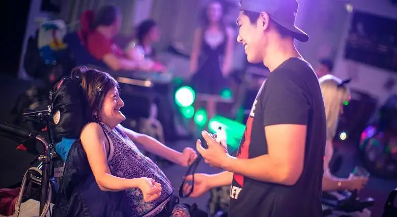 Woman in a wheelchair talking to a personal assistant at Revitalise accessible holiday