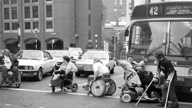 Black and white image from the 60s of disaled people blocking a road
