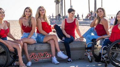 Rollettes possed in front of a beach all wearing red tops