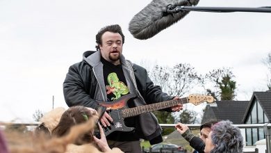 James Martin holding a guitar at a music festival in the film Ups and Downs
