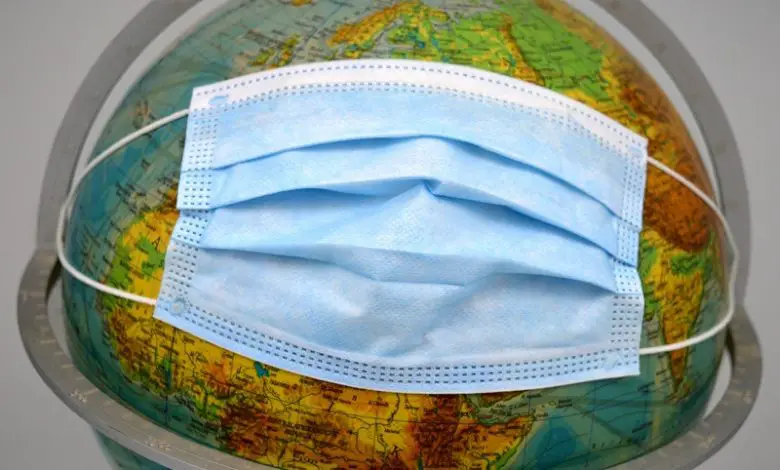 Globe showing the world with a paper mask over it
