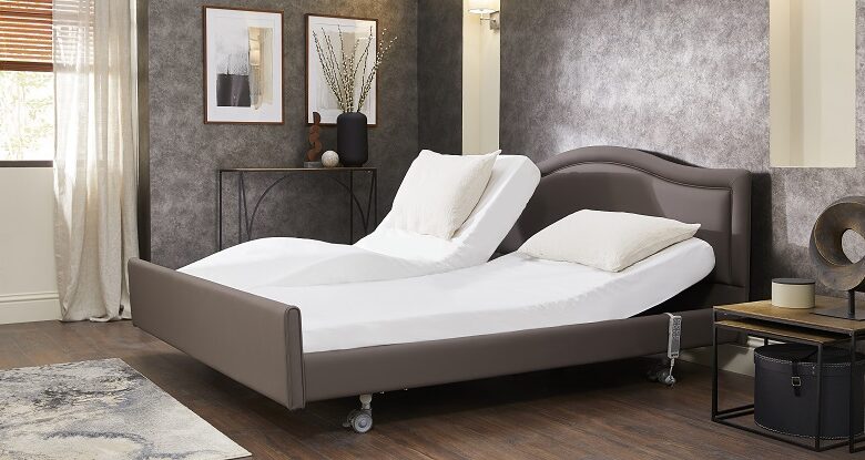 Opera Care profiling bed upholstered in mushroom fabric