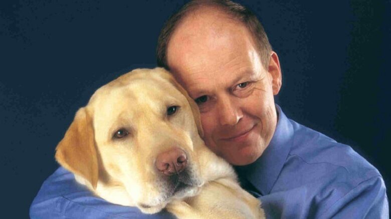 Allen Parton cuddling his assistance dog Endal