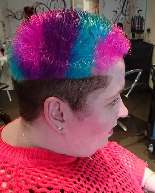 Danielle with an undercut and pink, purple and turquoise hair on top