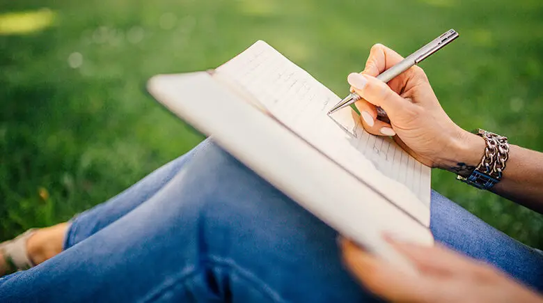 Lady writing in journal - by Negative Space