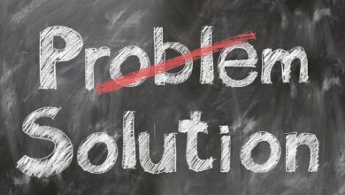 Black board with the word problems crossed out and the word solutions below it