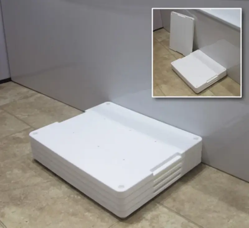 White plastic bath step next to a bath