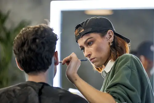 Sophie Baverstock applying make-up to model/performer on Glow Up