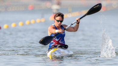 Emma Wiggs sitting in Canoe with paddle in hand