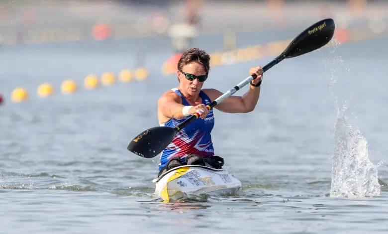 Emma Wiggs sitting in Canoe with paddle in hand