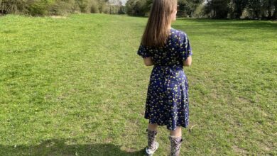 Chloe Tear stood outdoors with her back facing the camera