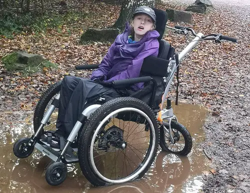 Charlene Cooper in her Mountain Trike Push all-terrain wheelchair in the Forest of Dean