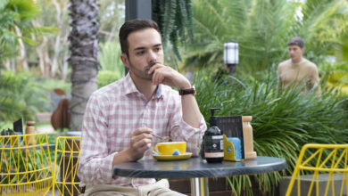 Nathan Borg as Curtis Perkins sitting at garden table thinking intently