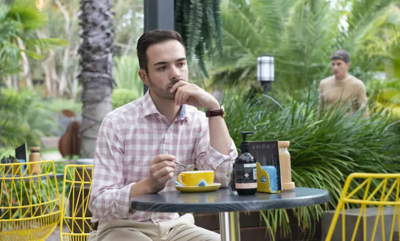 Nathan Borg as Curtis Perkins sitting at garden table thinking intently