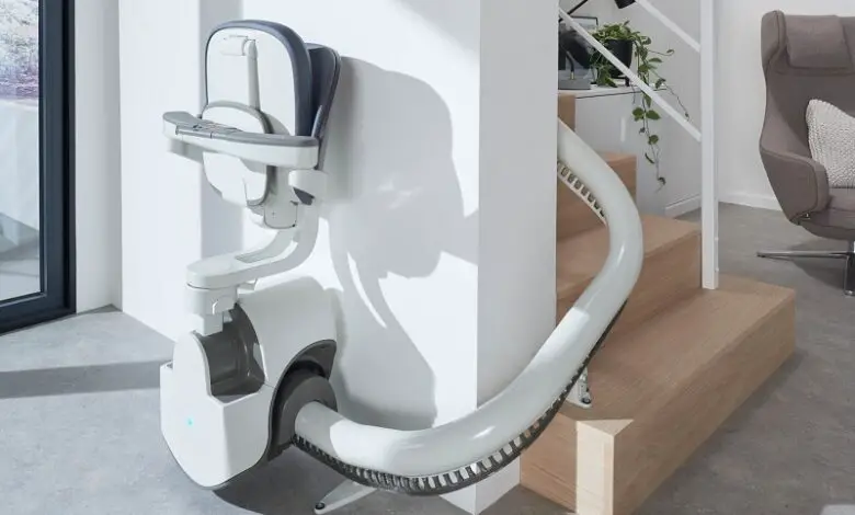 Flow X curved stairlift at the bottom on stairs with the seat folded up