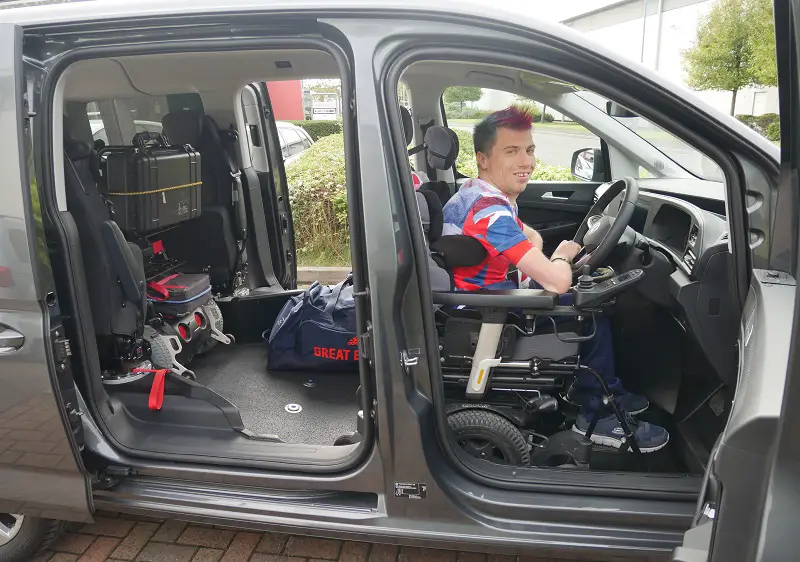 Paralympian David Smith sat in the driver's seat in his wheelchair in the new Sirus VW Caddy Maxi Life 5 with all doors open