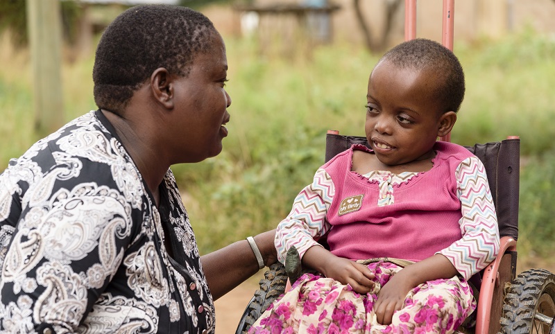 Avina sat in her wheelchair with her mother Prisca(32).